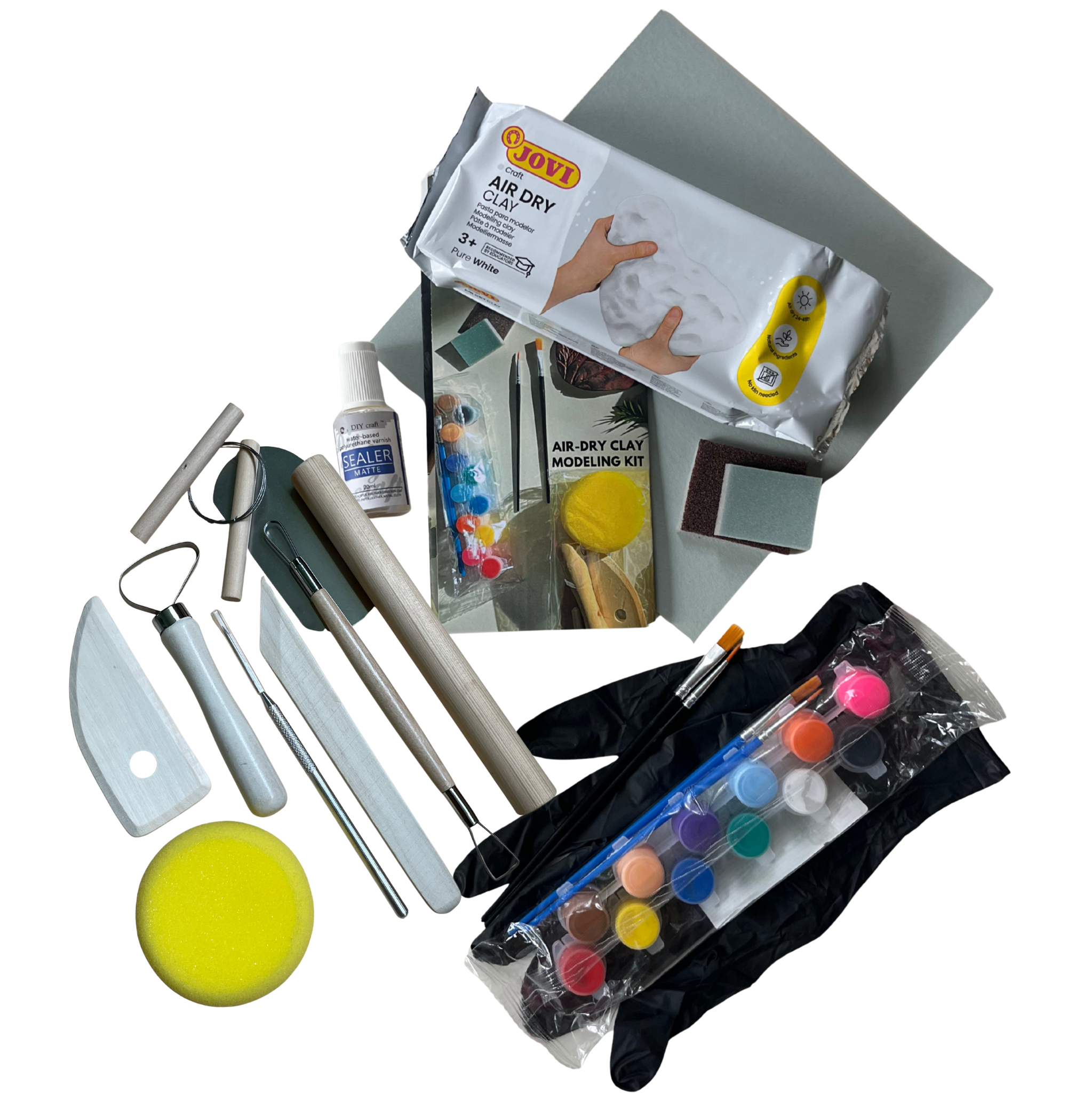 Art supplies including clay, tools, and paint on a white background