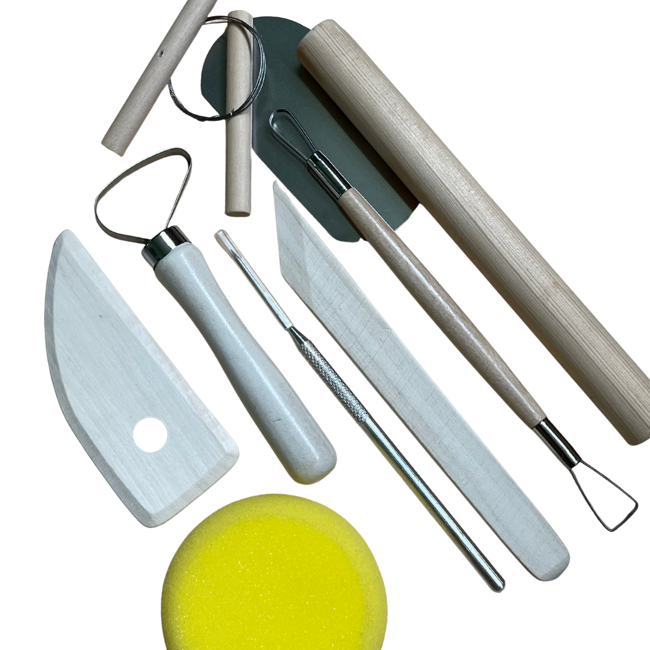 Set of ceramic tools including a knife, sponges, and brushes on a white background