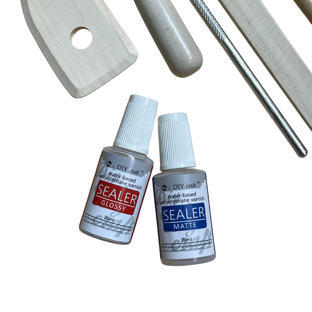 Two bottles of sealer labeled 'Gloss' and 'Matte' with tools on a white background.